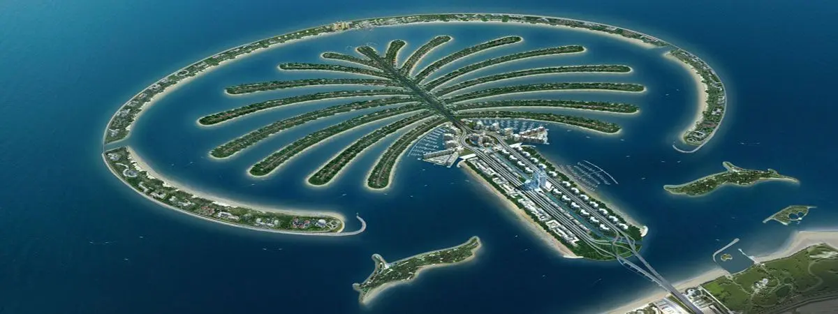Aerial photograph of Palm Jumeirah Dubai showing the full palm tree shaped man-made island with the Crescent, Fronds, and Trunk residential and hotel communities
