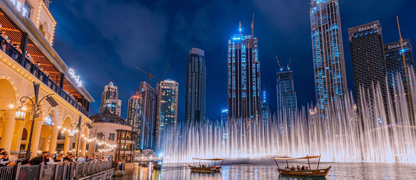 Burj Khalifa and Dubai Fountain illuminated at night viewed from Burj Lake boardwalk in Downtown Dubai