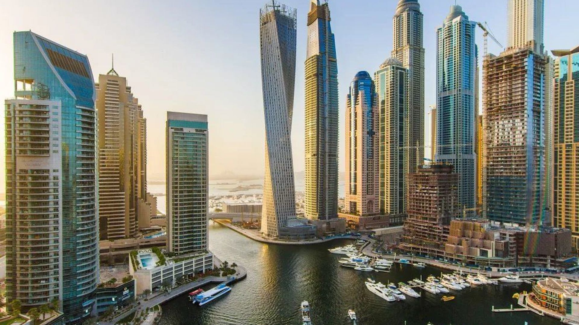 Cayan Tower twisting residential skyscraper against Dubai Marina skyline representing iconic architecture in the community