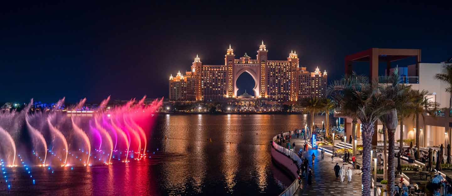 The Pointe outdoor waterfront dining and entertainment destination on Palm Jumeirah Dubai at dusk with Atlantis The Royal illuminated in the background